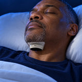 A man asleep wearing Hushlea Pro under his chin